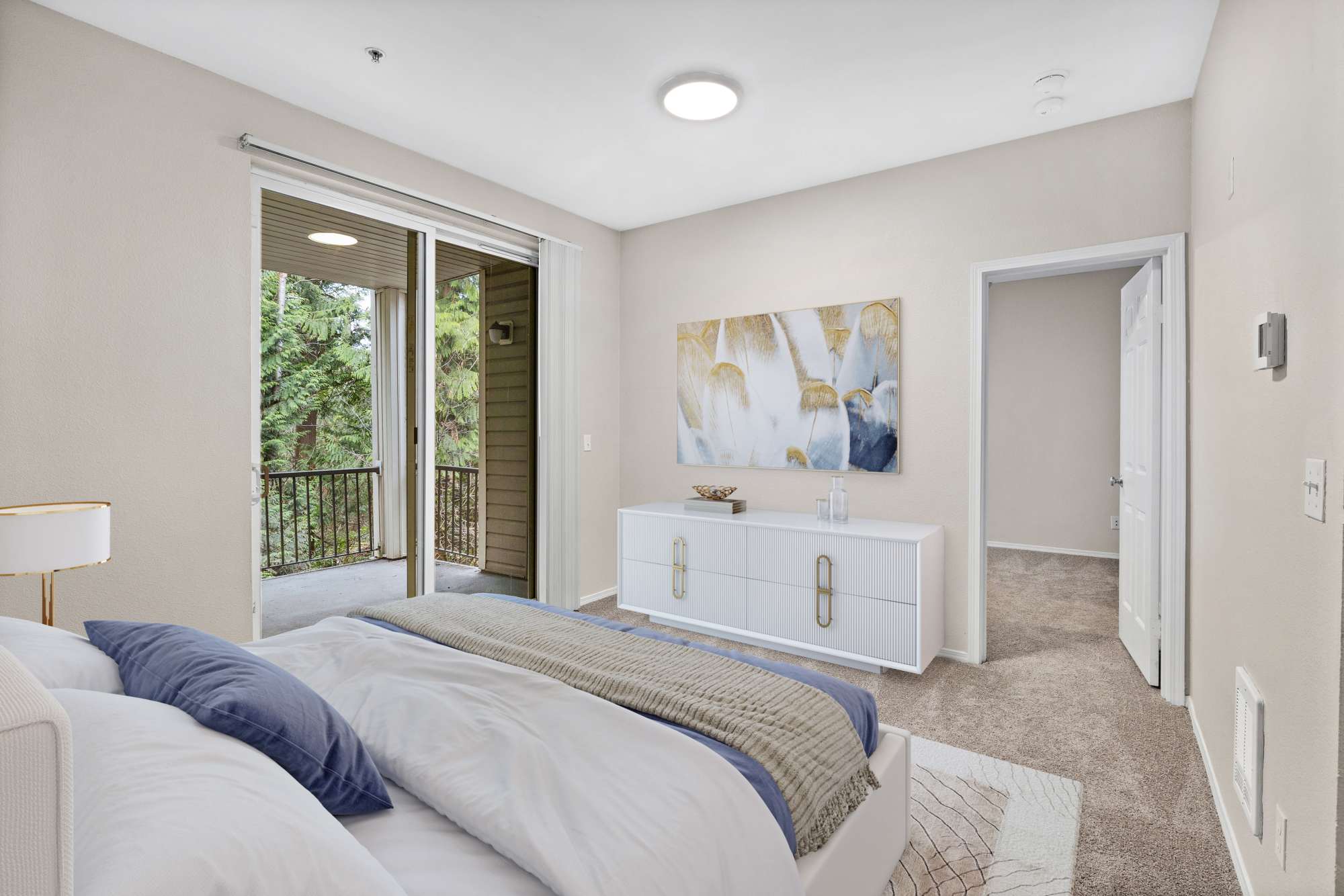Bedroom withh dome light and carpet flooring at Wildreed Apartments in Everett, Washington