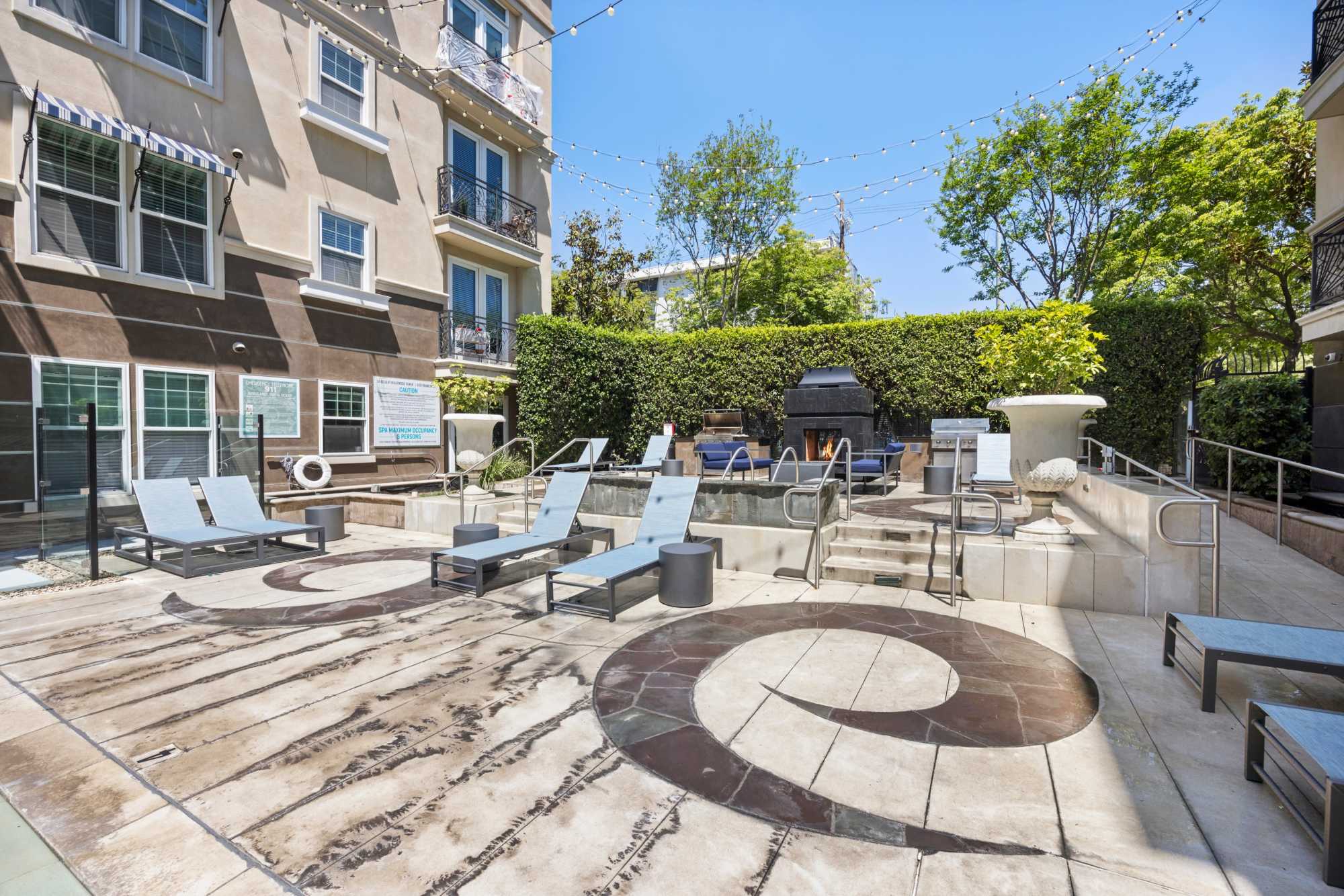Relaxing Spa and Fireplace next to BBQs with Lounge Area at La Belle at Hollywood Tower in Los Angeles, California