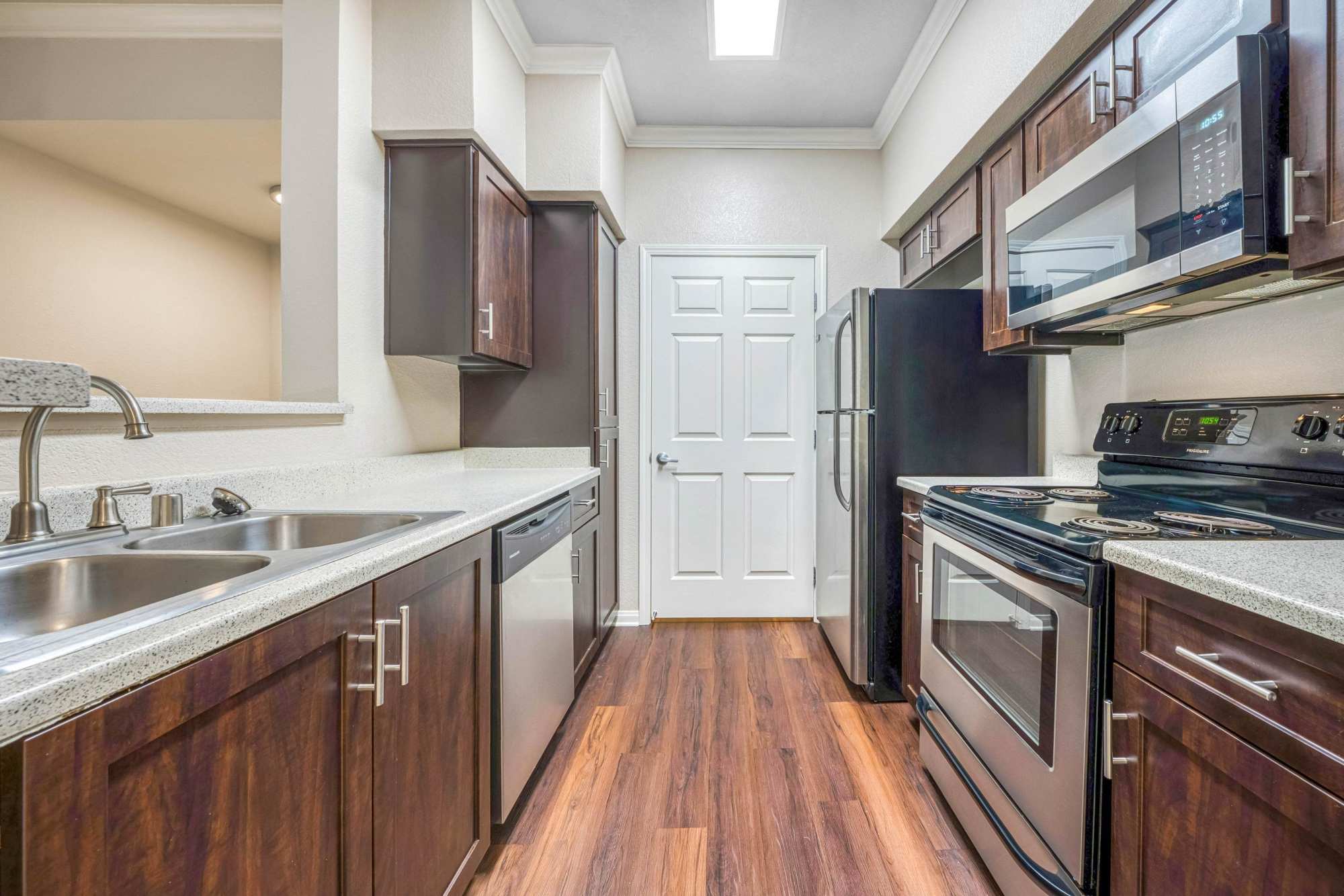 Kitchen with stainless-steel appliances and an island at Hawthorn Village Apartments in Napa, California