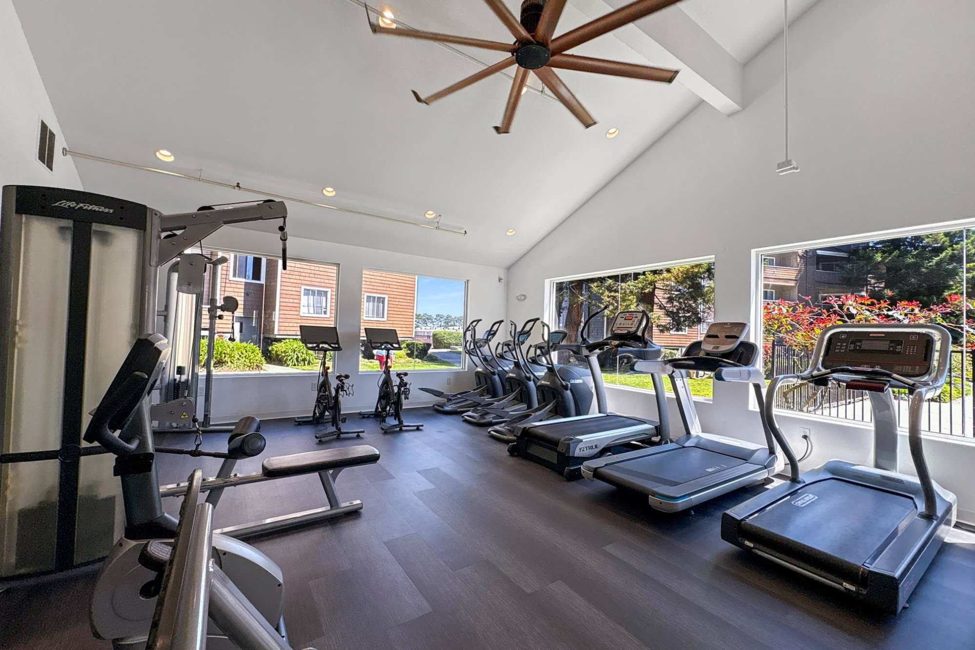 Full-Equipped Fitness Center with Cardio Machines and Weights at Serramonte Ridge Apartment Homes in Daly City, California