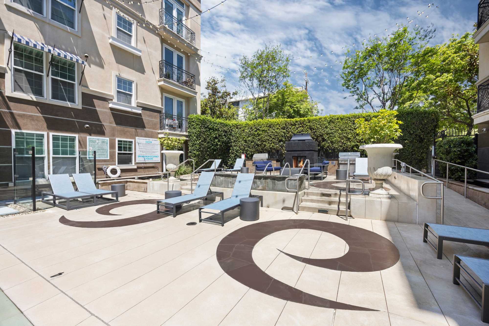 Relaxing Spa and Fireplace next to BBQs with Lounge Area at La Belle at Hollywood Tower in Los Angeles, California