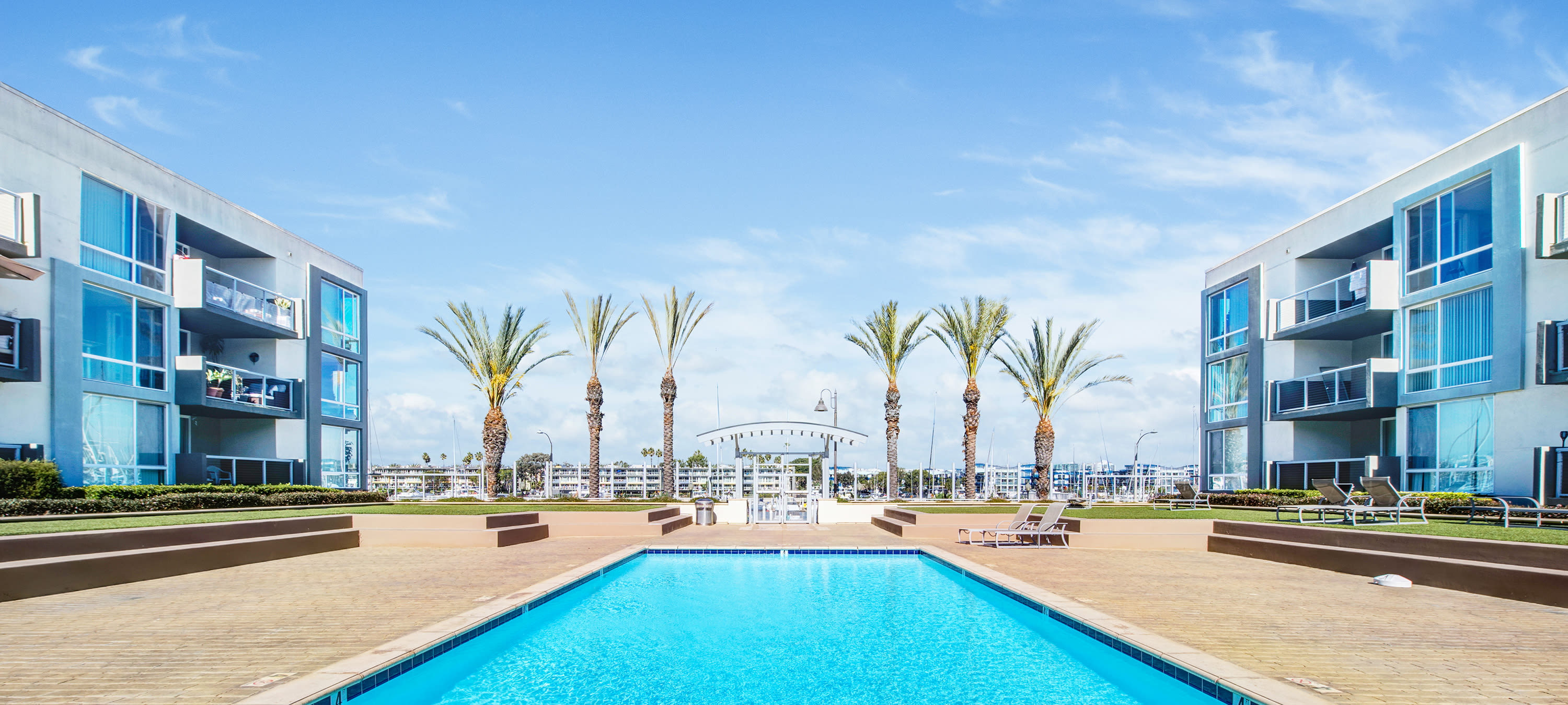 Palm trees and lush landscaping at Waters Edge waterfront apartments at Marina Harbor in Marina del Rey, California