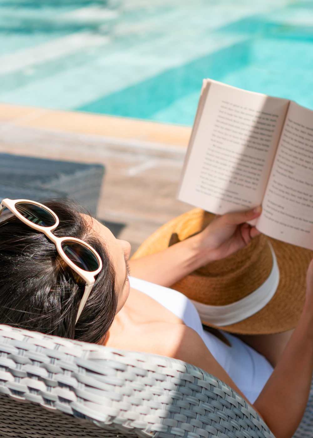 Resident reading by the pool at La Serena at the Parque in North Las Vegas, Nevada