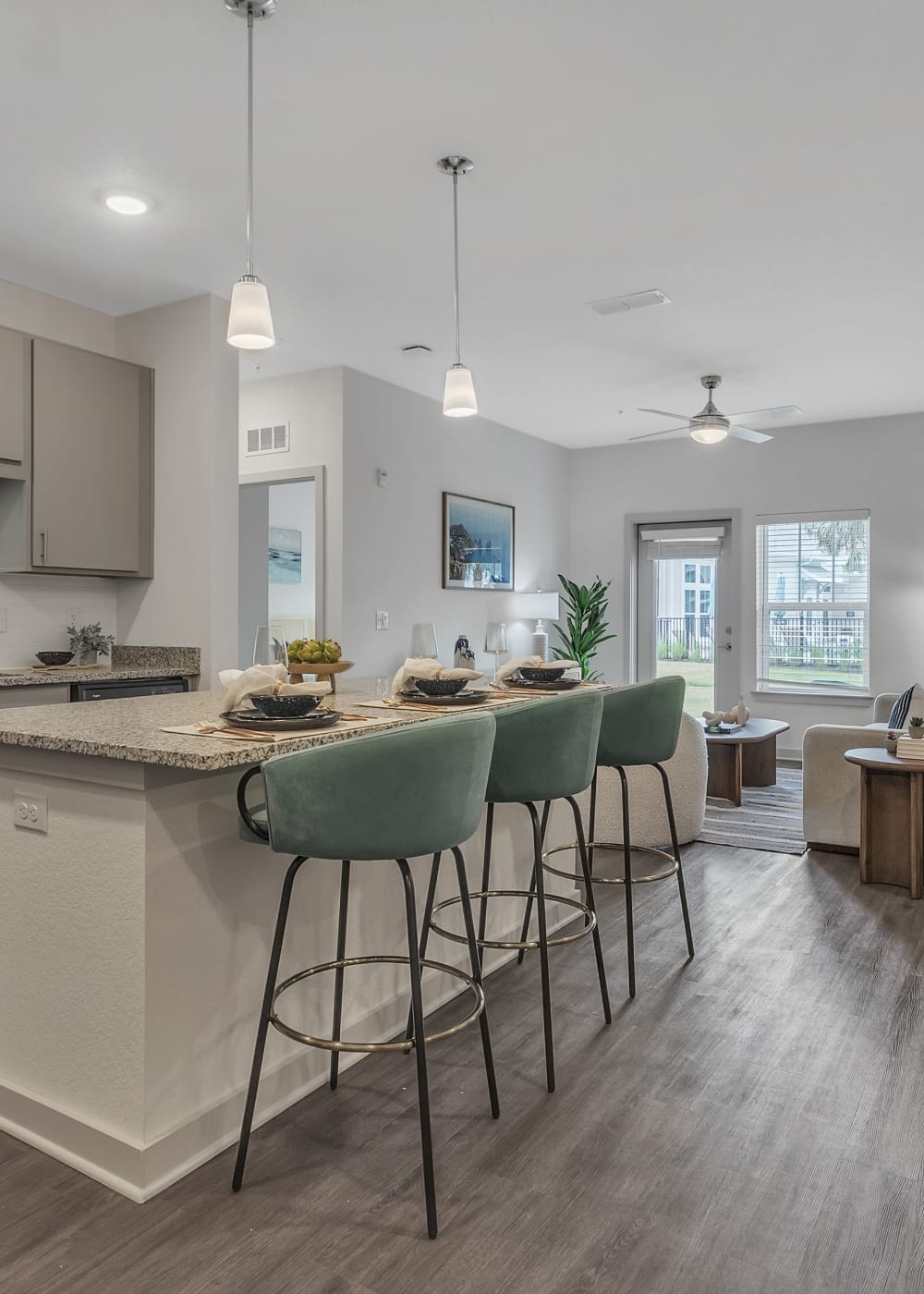An apartment kitchen island with bar seating at Avocet at Melbourne in Melbourne, Florida