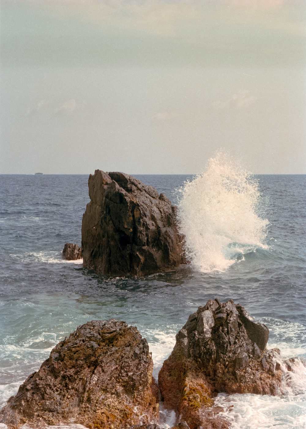 Rocky coastline with splashing waves and serene ocean backdrop at Colony Parc in Ventura, California