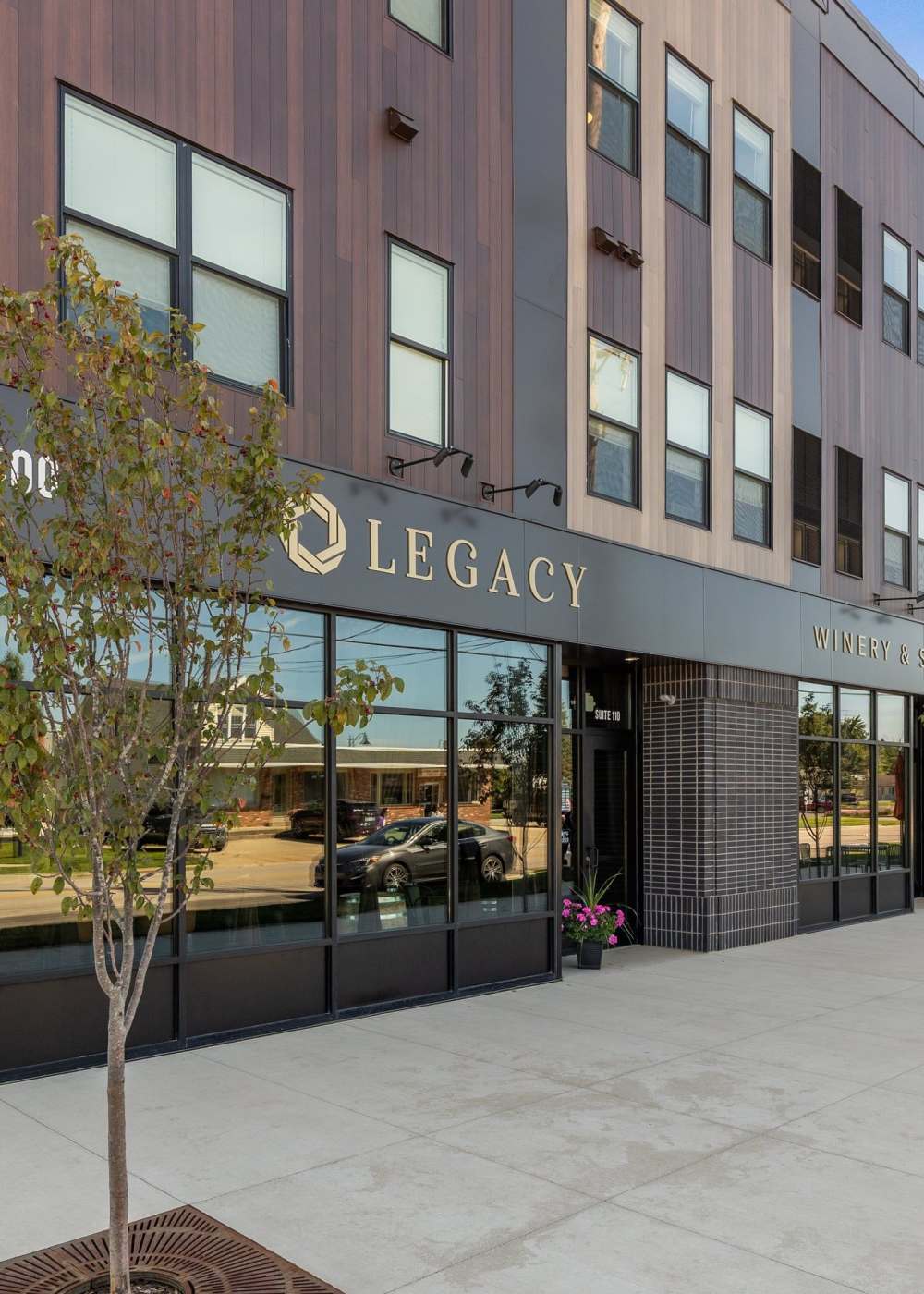 Modern apartment building with private balconies and contemporary exterior finishes at Terra Station in Hudsonville, Michigan