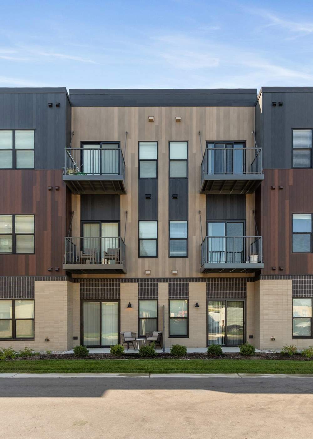 Exterior view of contemporary apartment residences with balconies at Terra Station in Hudsonville, Michigan