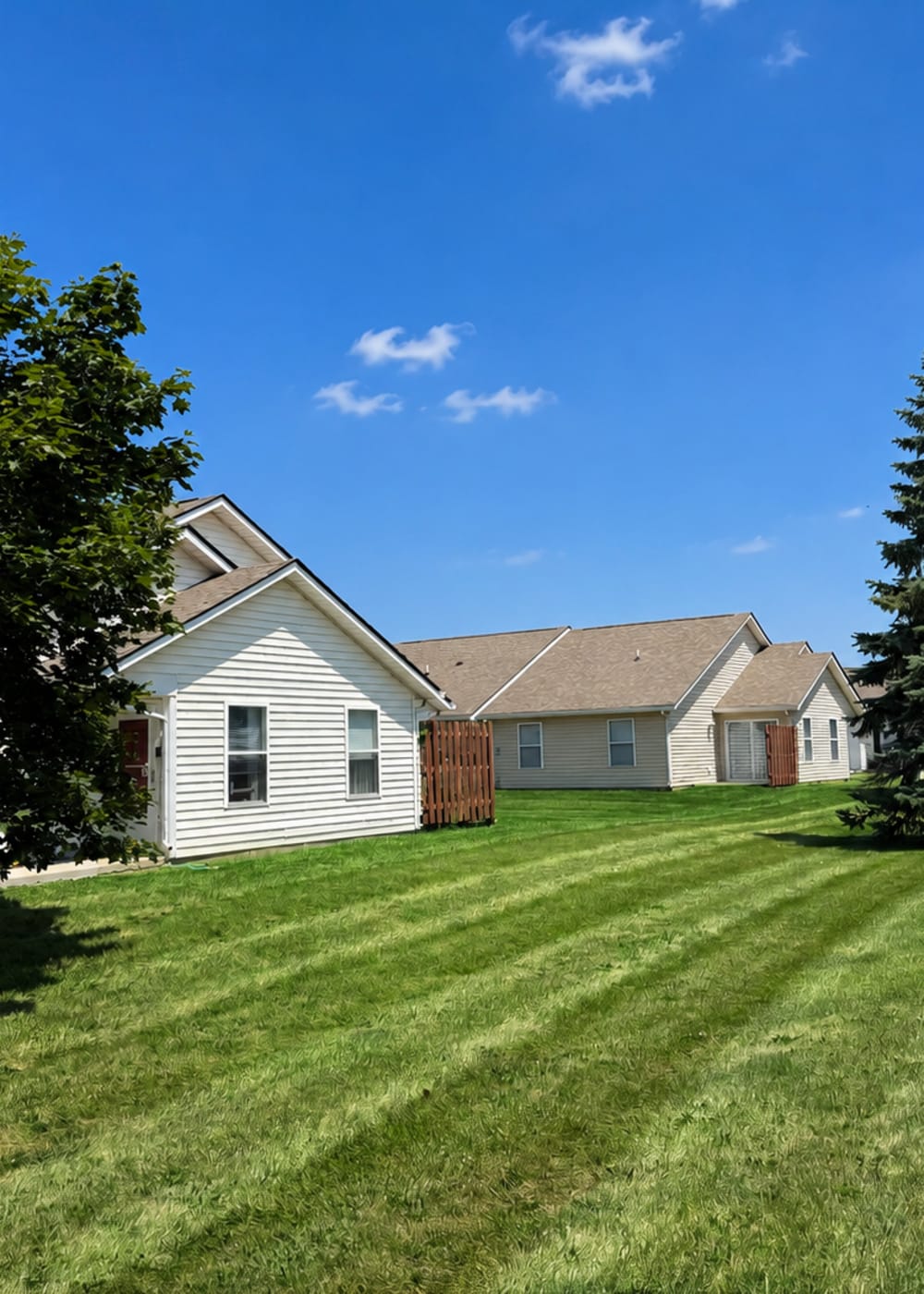 Apartment exterior with lawn at Broadway Village Apartments in Greenfield, Indiana