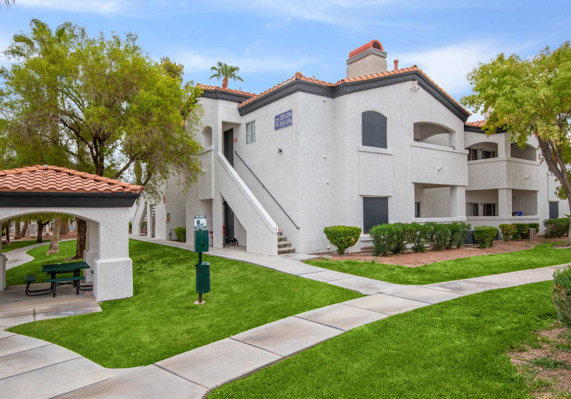 A walkway displaying the beautiful apartment exteriors of Tides on Tropicana in Las Vegas, Nevada