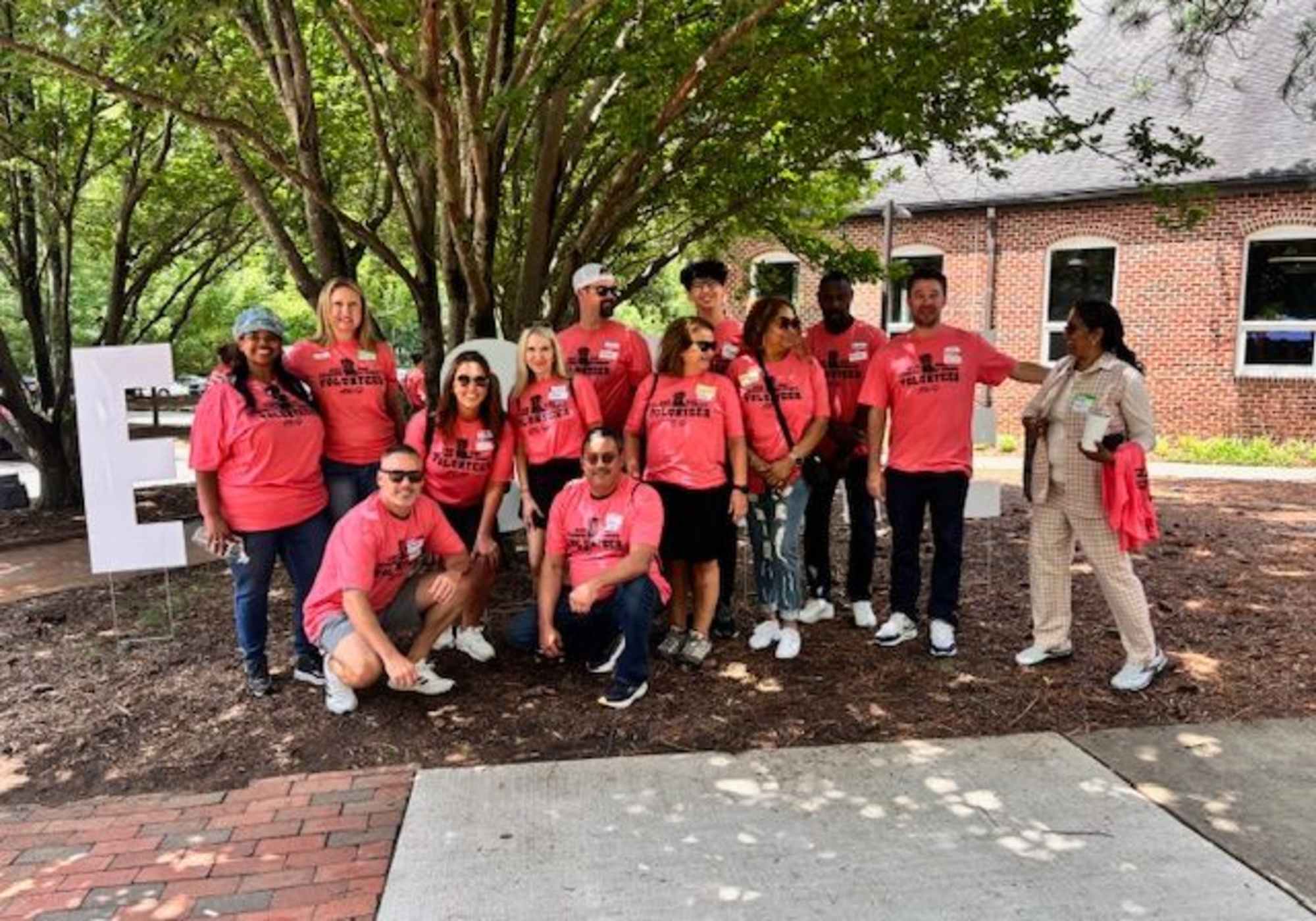 A group of people smiling and posing together for a photo at a social event at Drucker + Falk in Newport News Virginia