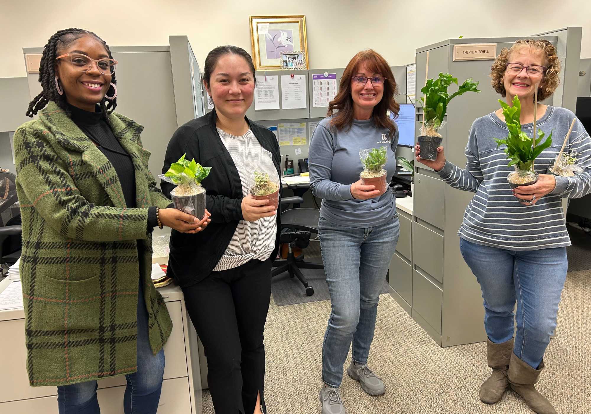 Women holding the flower pots at Drucker + Falk in Newport News Virginia