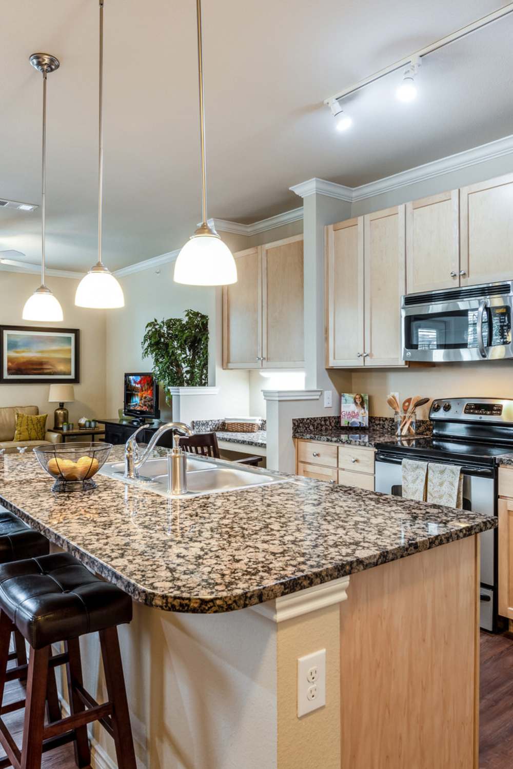 Apartment kitchen with lights at Renaissance At North Park in Lubbock, Texas