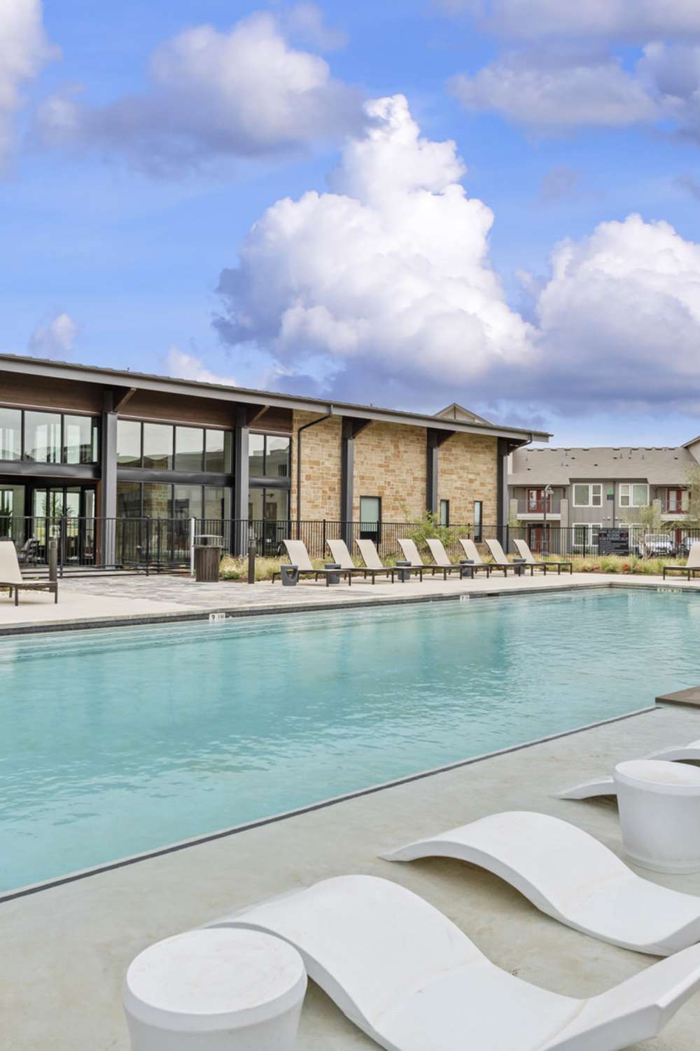 Sun loungers by the pool side at Slide North Apartments in Lubbock, Texas