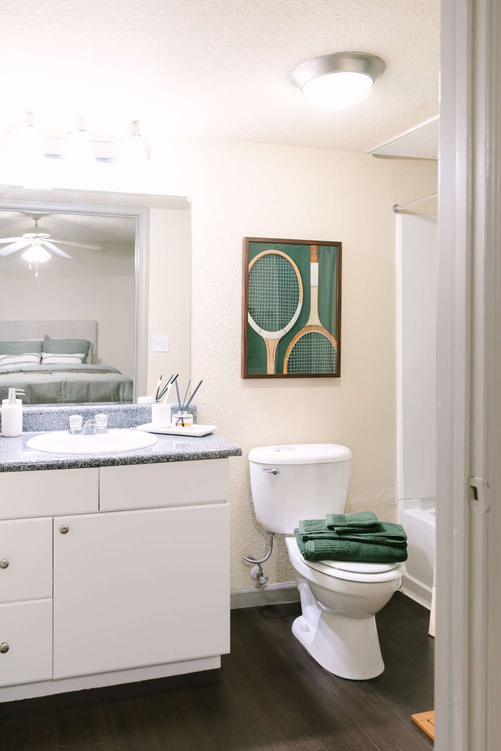 Apartment bathroom with vanity, tub-shower combination, and modern finishes  at The Holly in Lubbock, Texas.