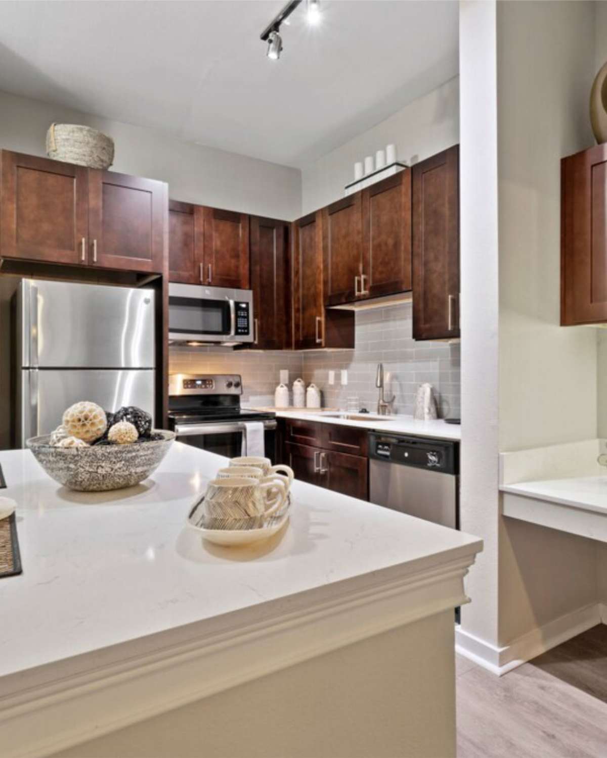Model kitchen with stainless-steel appliances at Arbor Hills at Flatiron District at Austin Ranch in The Colony, Texas