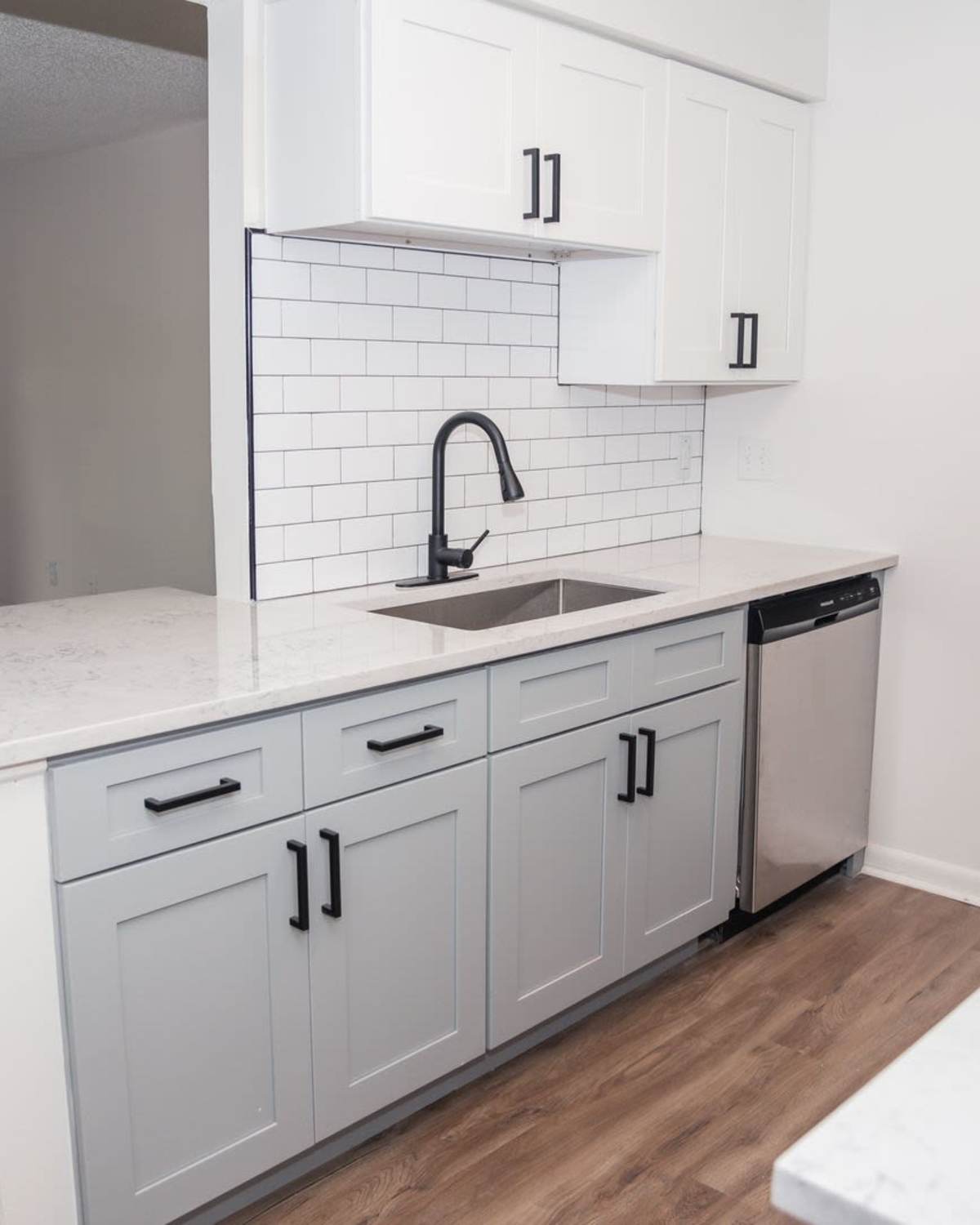 Resident cooking in  kitchen at Wallace Terrace Apartments in Charlotte, North Carolina