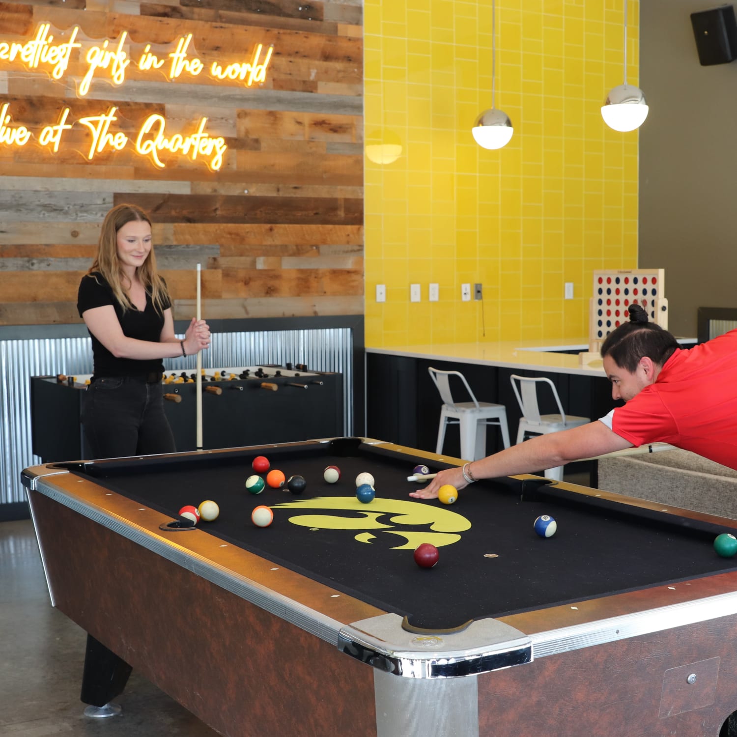 Residents playing pool at The Quarters at Iowa City in Iowa City, Iowa