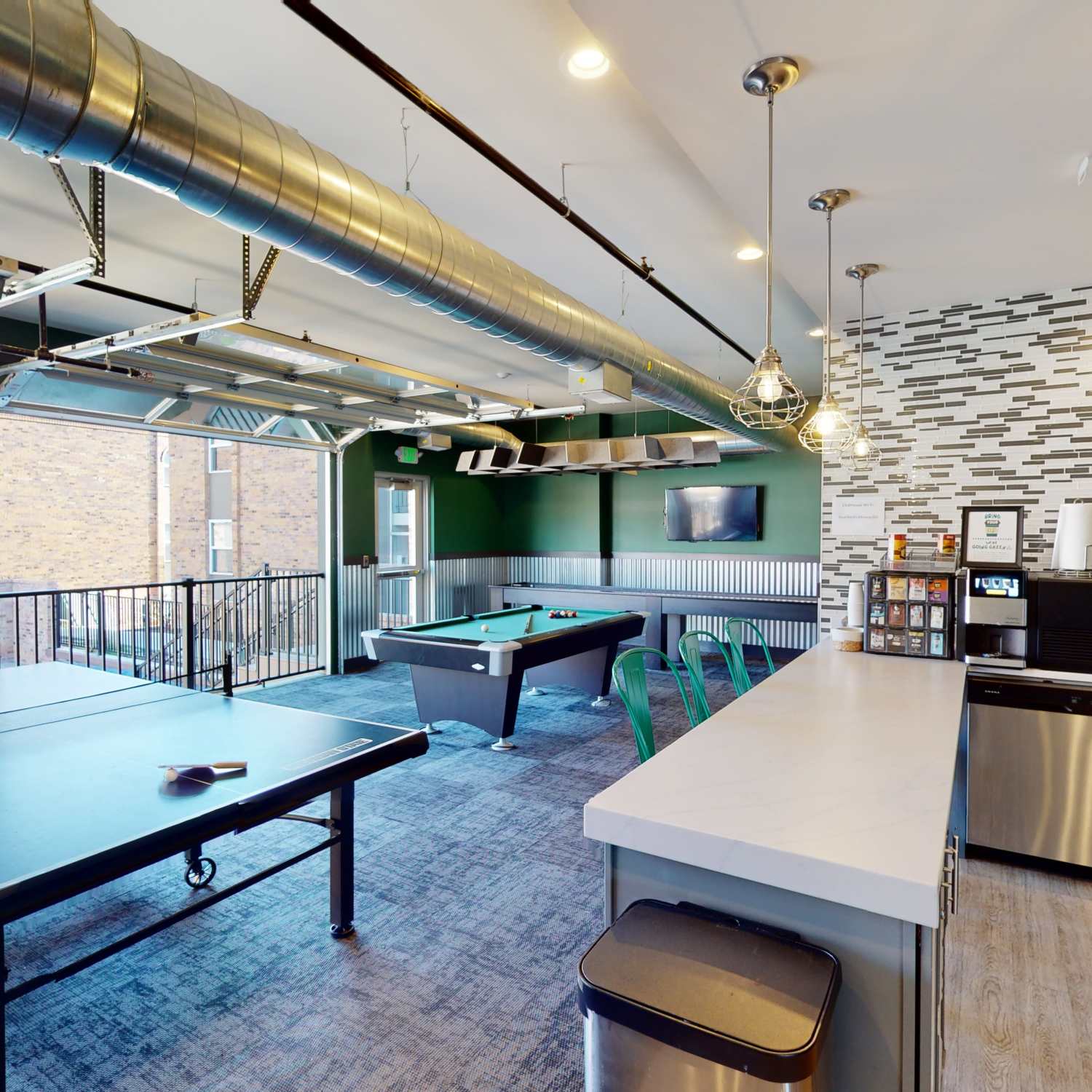 Resident clubhouse with ping pong and billiard table at The Quarters East Lansing in East Lansing, Michigan