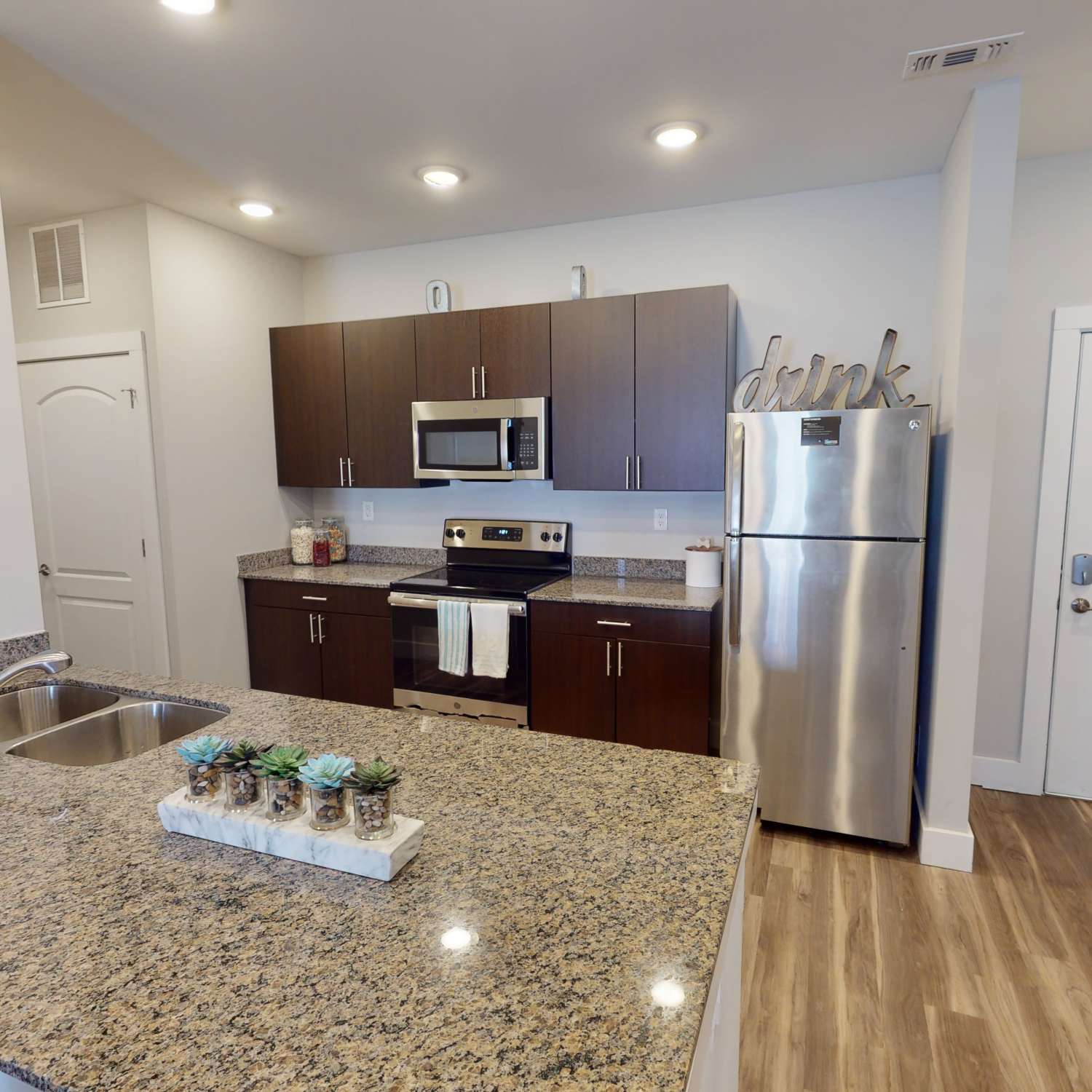 Kitchen with stainless-steel appliances at The Quarters at Bloomington in Bloomington, Indiana