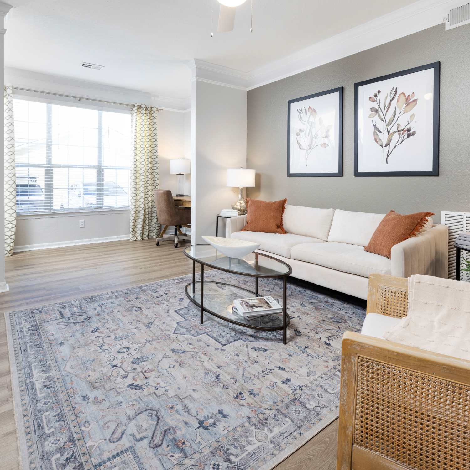 Modern furnishings and hardwood-style flooring in a model home's living space at Arbors at Cahaba River in Birmingham, Alabama