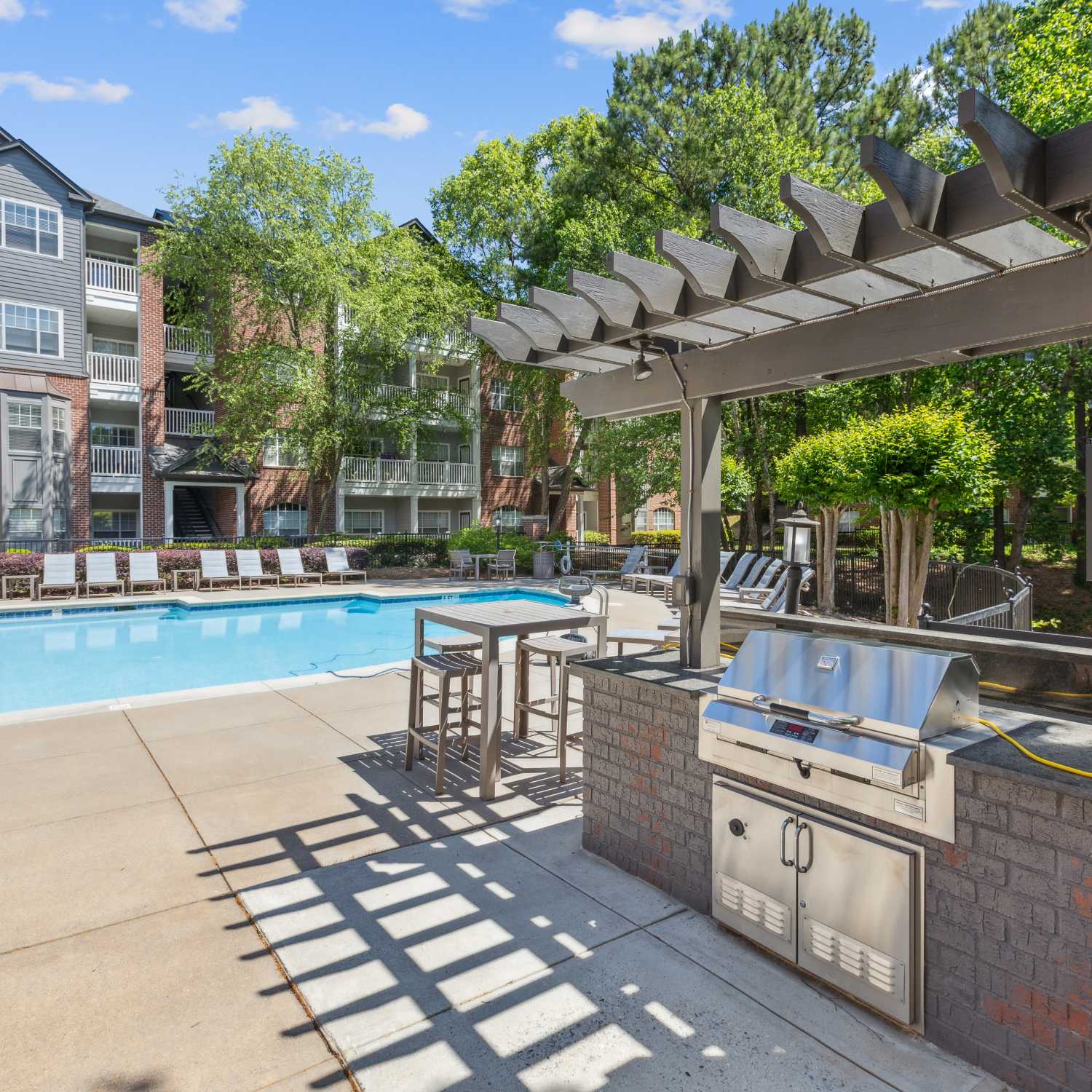 Swimming pool with patio and lounge chairs at The Kinsley at Perimeter Center in Atlanta, Georgia