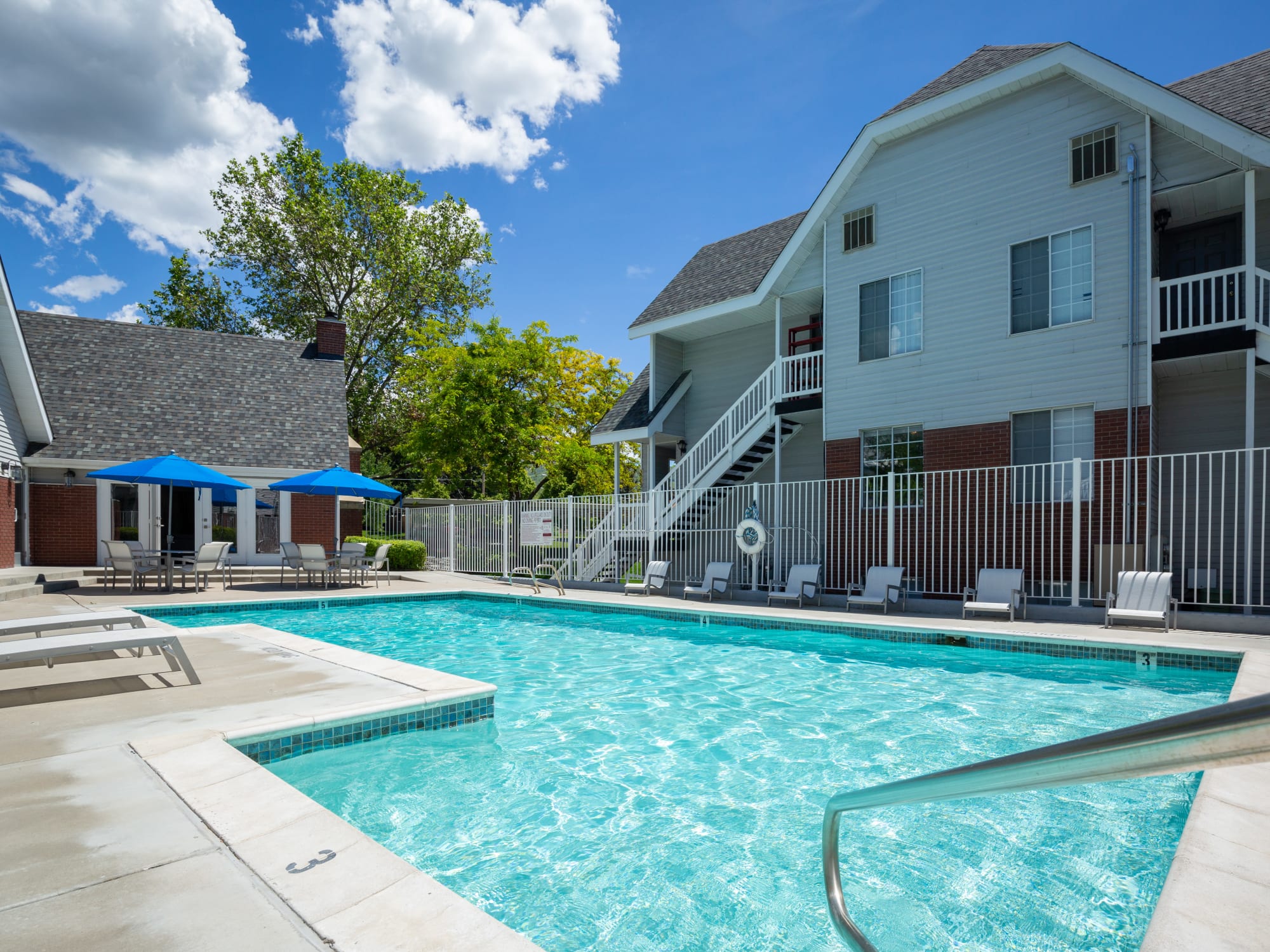 Sparkling Pool View with lounge chairs and umbrellas in Bountiful, Utah