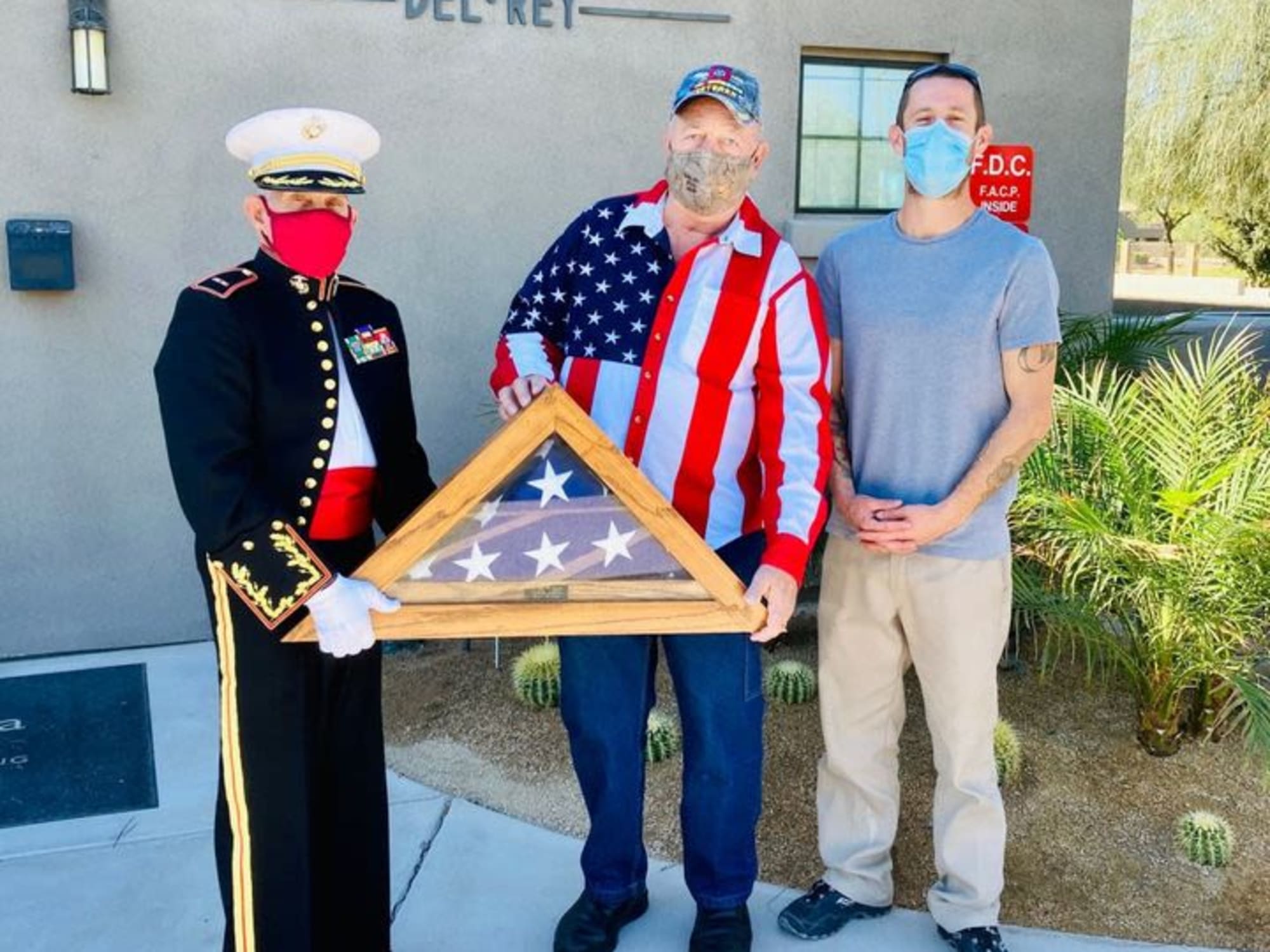 Veterans posing with a trifold flag at Hacienda Del Rey in Litchfield Park, AZ