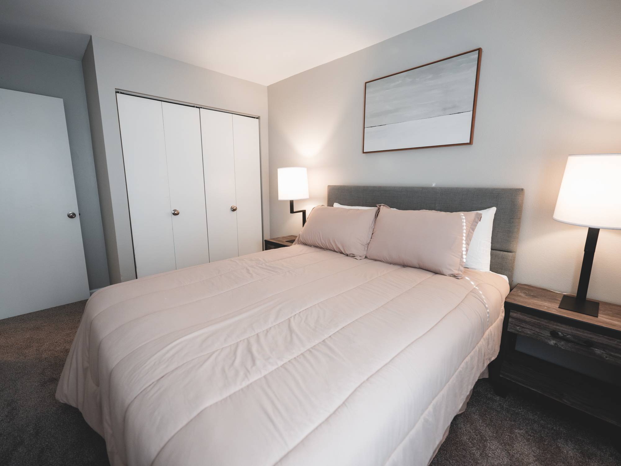 Model bedroom with plenty of lighting at Wynnwood at Freedom Road in Cranberry Township, Pennsylvania