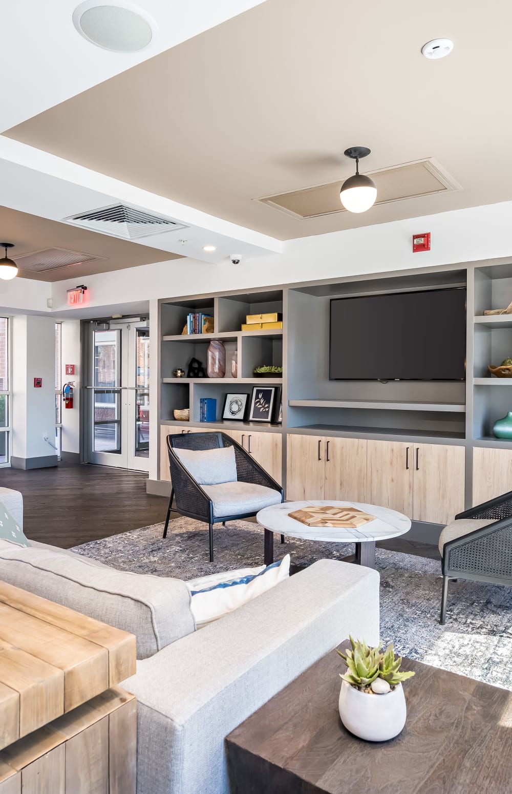 Resident clubhouse interior with couch and TV brick at Sofi at 50 Forest in Stamford, Connecticut