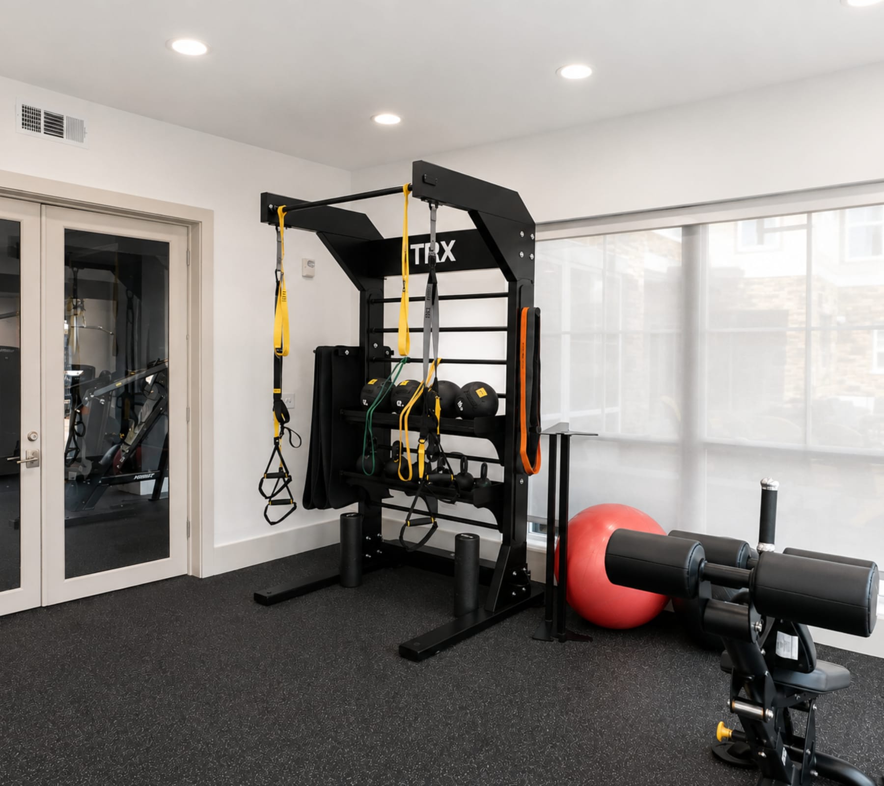 Private fitness room with weights and training equipment at The Den in Columbia, Missouri