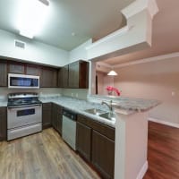 Kitchen with brown cabinet at River Pointe in Conroe, Texas