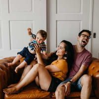 A Family enjoying time together in their apartment at Legacy Square, Plano, Texas