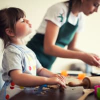 Kid helping her mom in kitchen at The Enclave at Delray Beach in Delray Beach, Florida