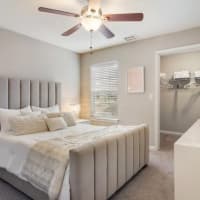 A furnished bedroom with a ceiling fan at Ten68 West in Dallas, Georgia