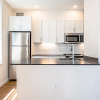 Large kitchen with island and stainless-steel appliances at One India Street Apartments in Boston, Massachusetts