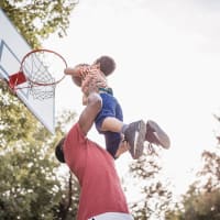 Dad and son playing basketball at Evergreen Terrace in Fairburn, Georgia