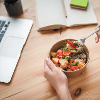 Resident eating a healthy lunch while working from home at Vista Apartments in Chula Vista, California