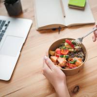 Resident eating a healthy lunch while working from home at Laurel Glen in Manteca, California