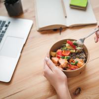 Resident eating a healthy lunch while working from home at Ellinwood in Pleasant Hill, California