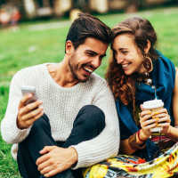 Happy couple having coffee at park near Hayu Tilixam in Portland, Oregon