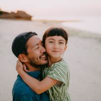 Father and daughter hanging out together at  The Landing at Fancher Creek in Fresno, California