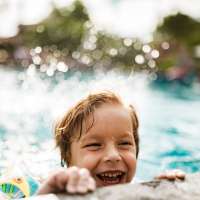 Kid playing in a pool at Remington Lake Apartments in Hamilton, Ohio