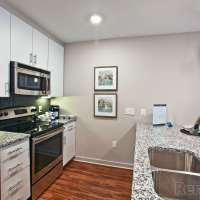 Stainless-steel appliances in an apartment kitchen at Environs Lofts at East 54 in Chapel Hill, North Carolina