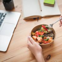 Resident eating a healthy lunch while working from home at Hayloft Big Creek in Alpharetta, Georgia