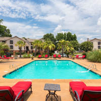 Resort-style swimming pool with multiple lounge chairs at The Arbors On Taylor in Montgomery, Alabama,