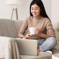 Happy resident using her larptop at Reve Park Ridge in Little River, South Carolina