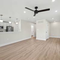 Living room with a ceiling fan at Lake Meadows in Garland, Texas