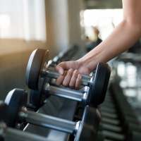 Resident working out in gym at Plantation West in Hurst, Texas