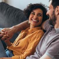 Happy couple on sofa at Lake Lucerne Towers in Orlando, Florida