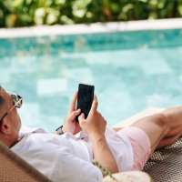 Resident relaxing by the pool at The Palmer in Orlando, Florida